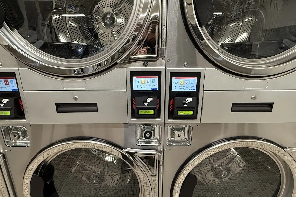 Row of high-efficiency commercial dryers for drying a sleeping bag at a Nelsonville, Ohio laundromat